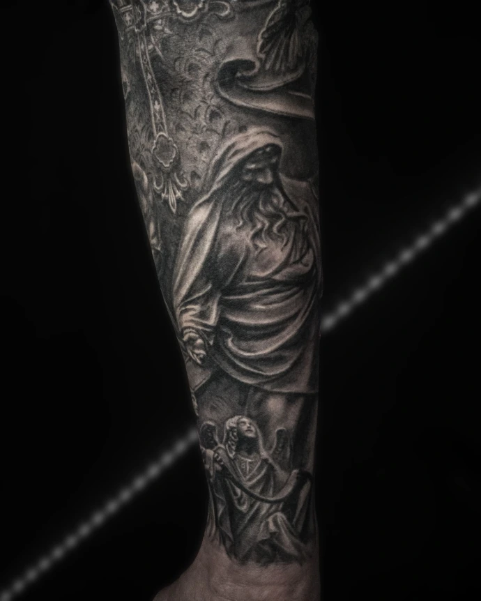 Forearm tattoo of a bearded saint or prophet rendered in a cracked stone statue style.
