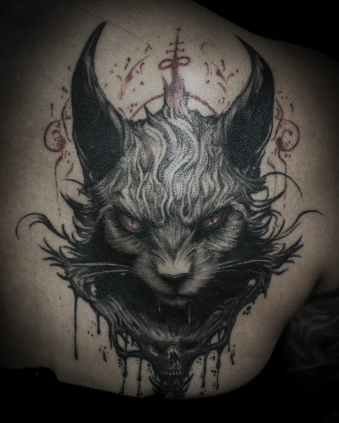 Dark surrealism tattoo of a demonic cat face with glowing red eyes, red occult sigils above the head, and a human skull morphing into the neck.